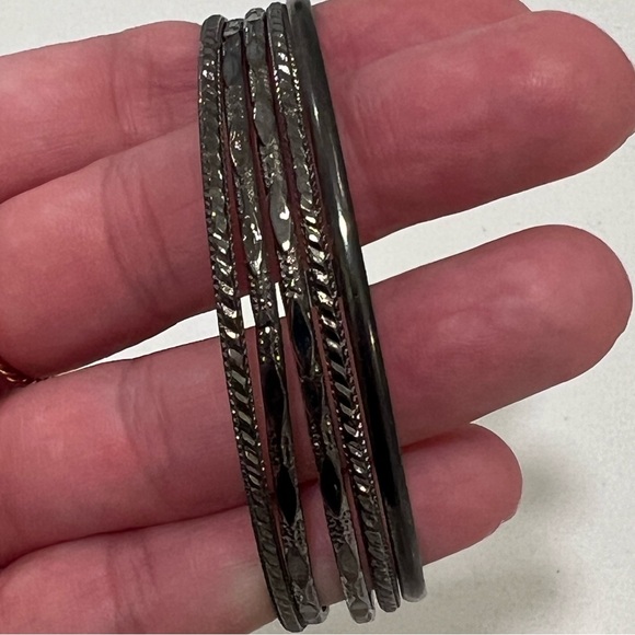 Black metal bracelet stack with different designs. - Picture 2 of 3